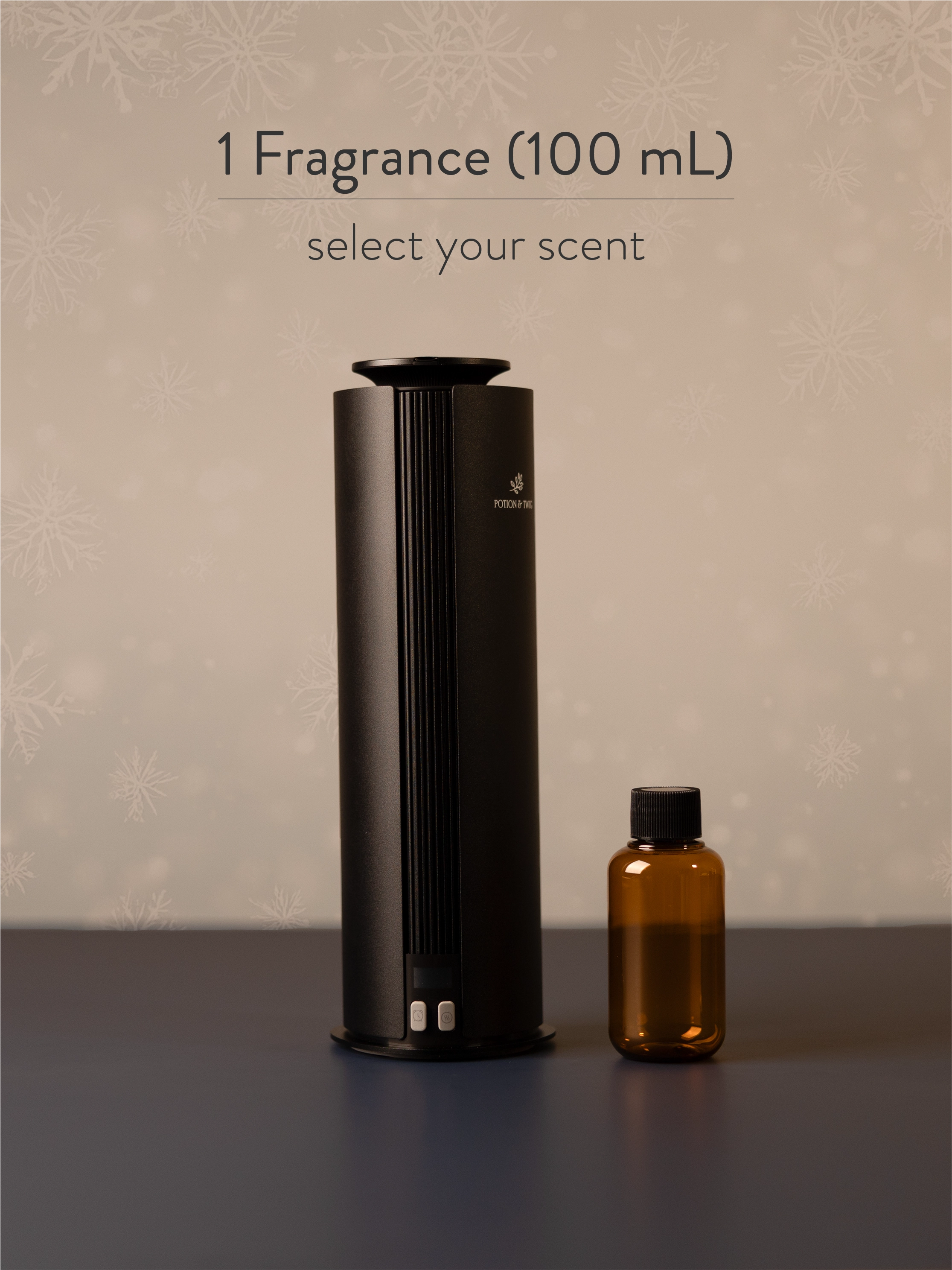 Black fragrance diffuser and small brown bottle on a dark surface with a beige background