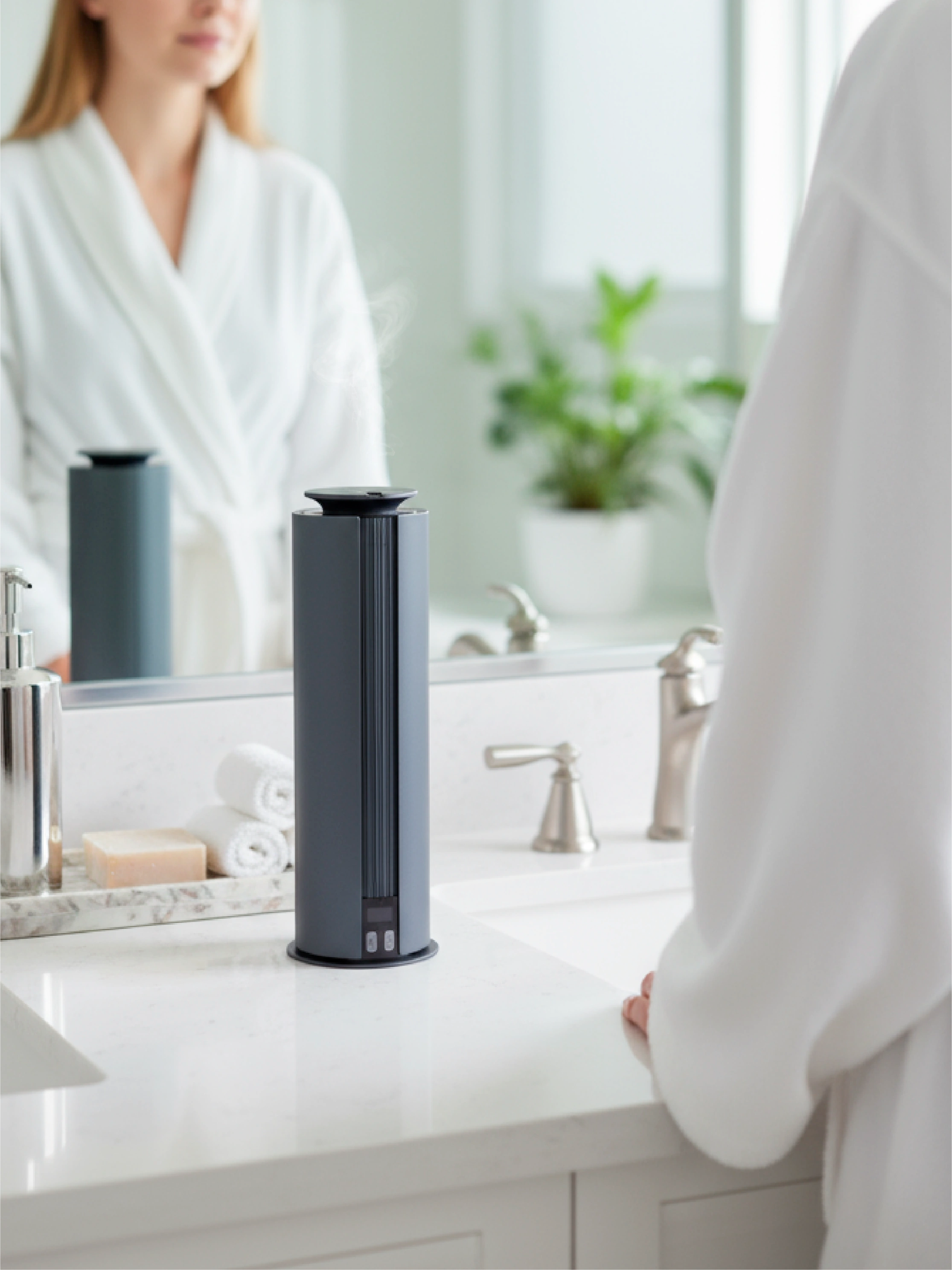 Spire wireless scent diffuser on a bathroom counter with a mirror in the background
