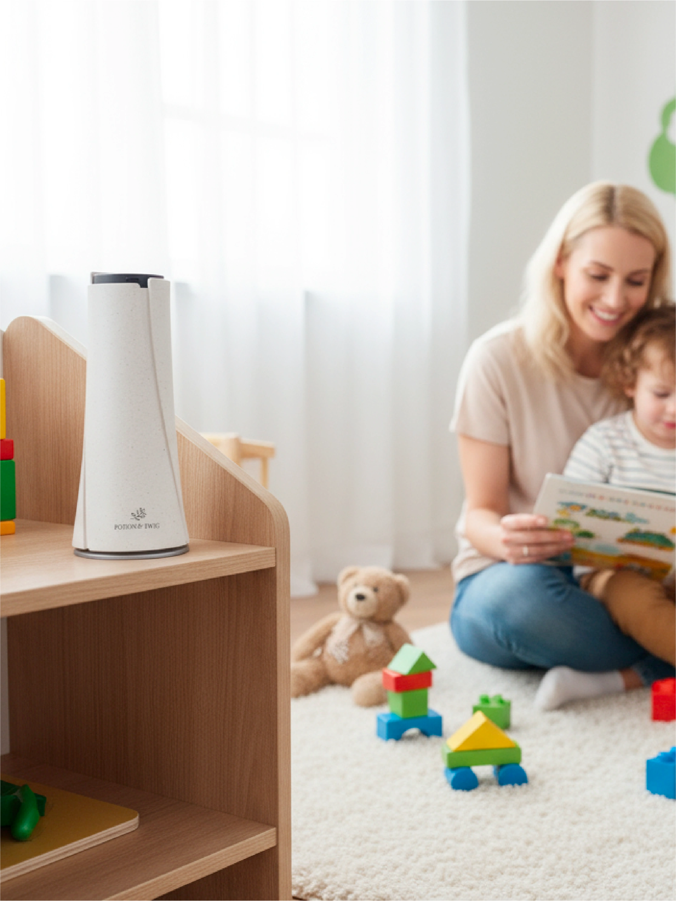 Woman and child playing with toys in a room with a white Lumen wireless scent diffuser on a wooden shelf.