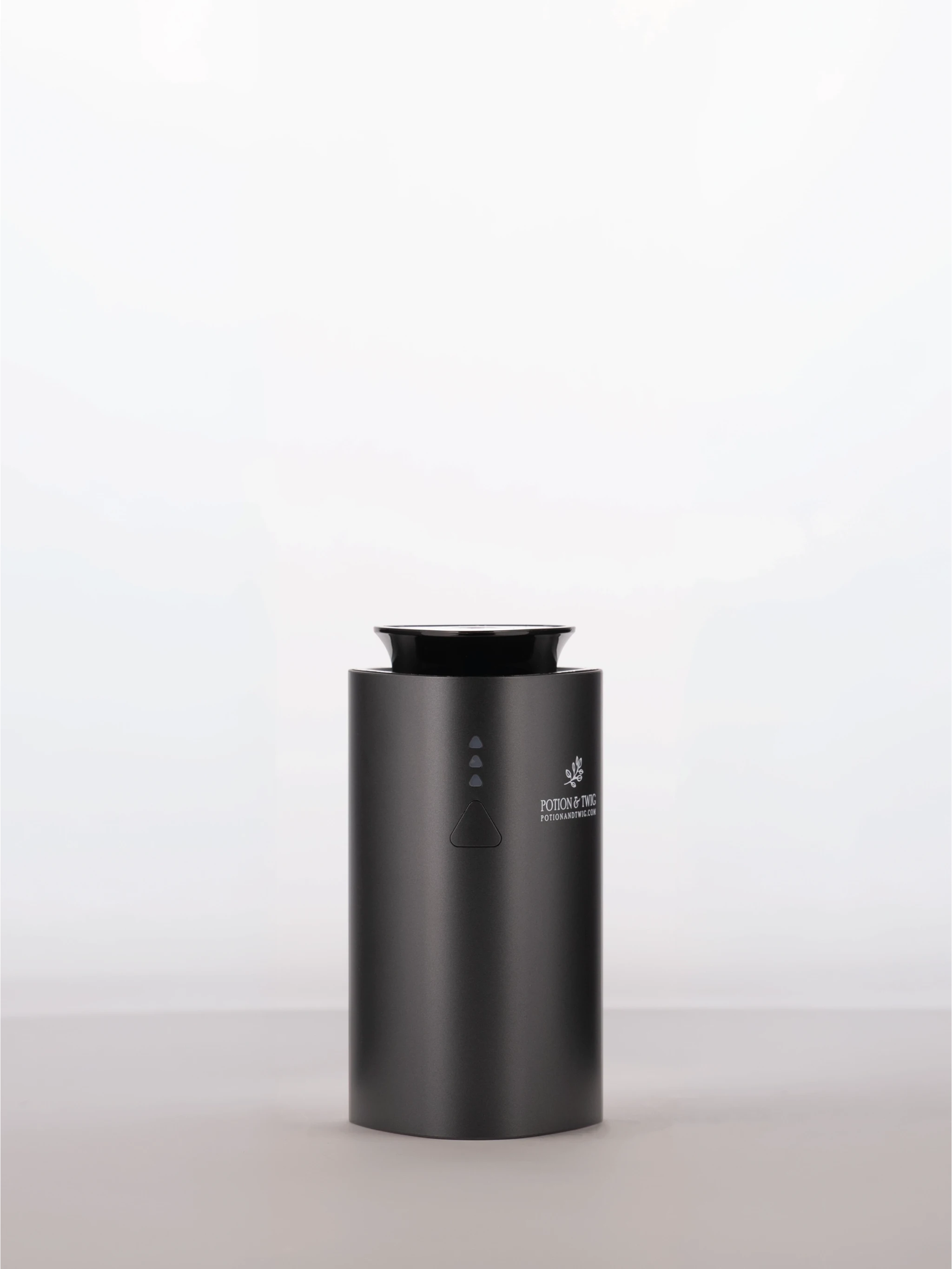 Black cylindrical scent diffuser with 'Potion & Twig' brand logo on a white background