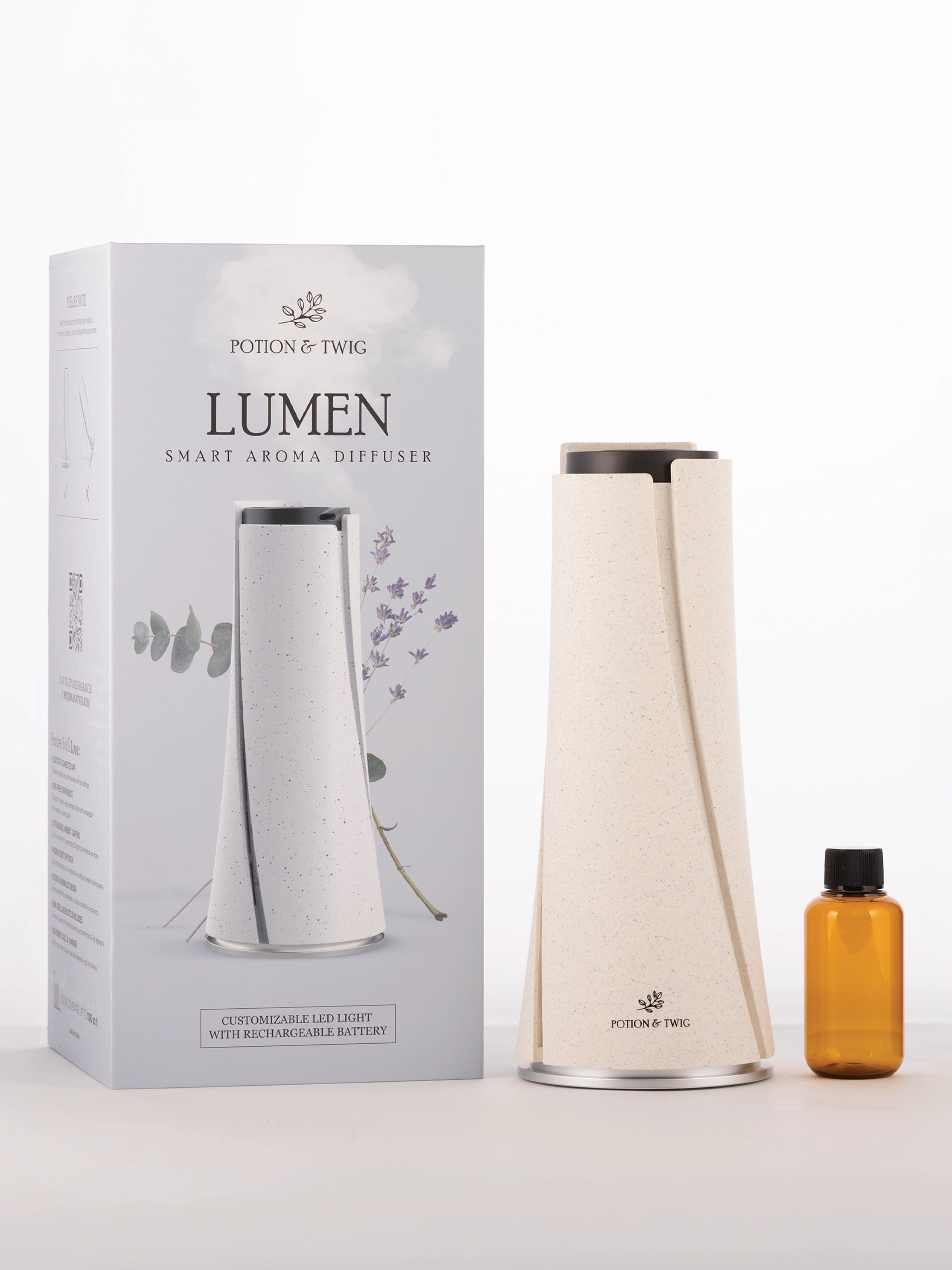 Lumen smart aroma diffuser with packaging and a small bottle on a white background