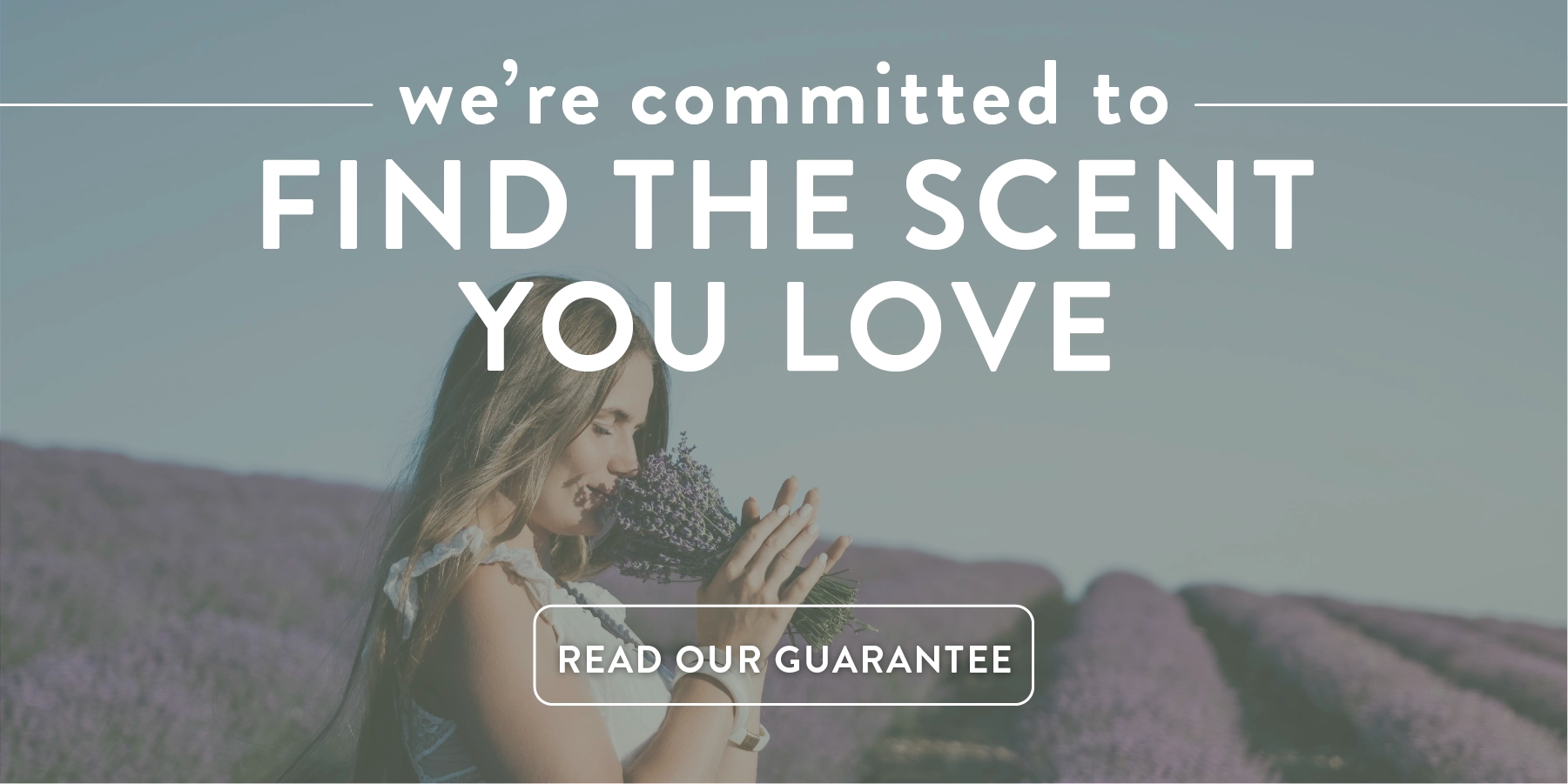 Woman holding lavender with text overlay 'we're committed to FIND THE SCENT YOU LOVE' in a lavender field.