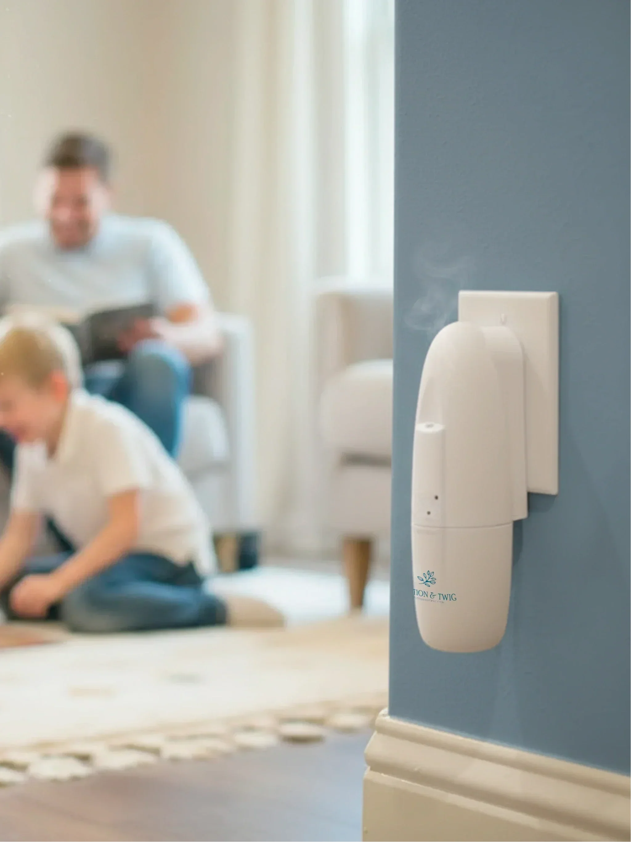 Sienna wall plug-in scent diffuser on a wall with a living room in the background