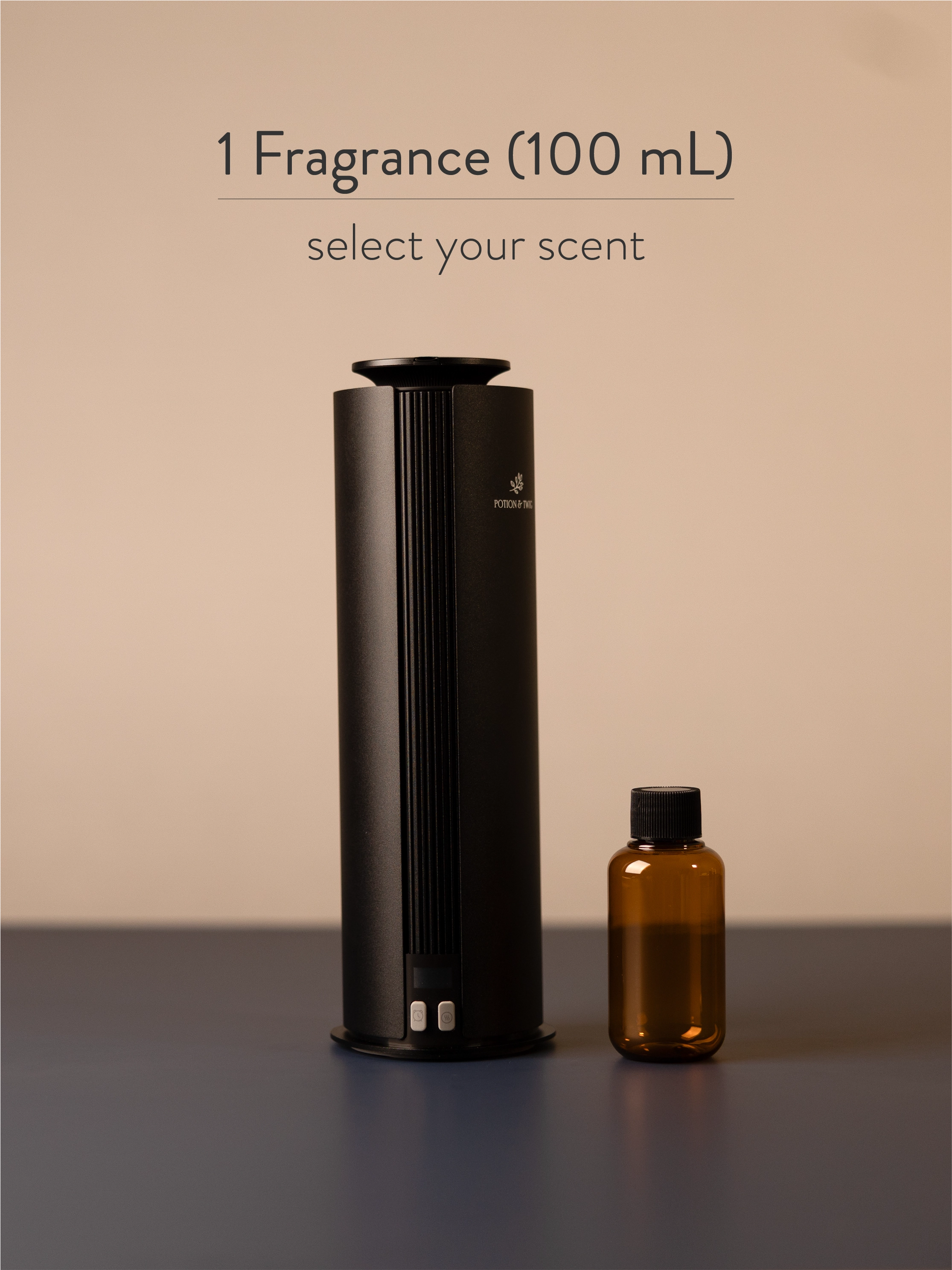Black fragrance diffuser and small brown bottle on a dark surface with a beige background