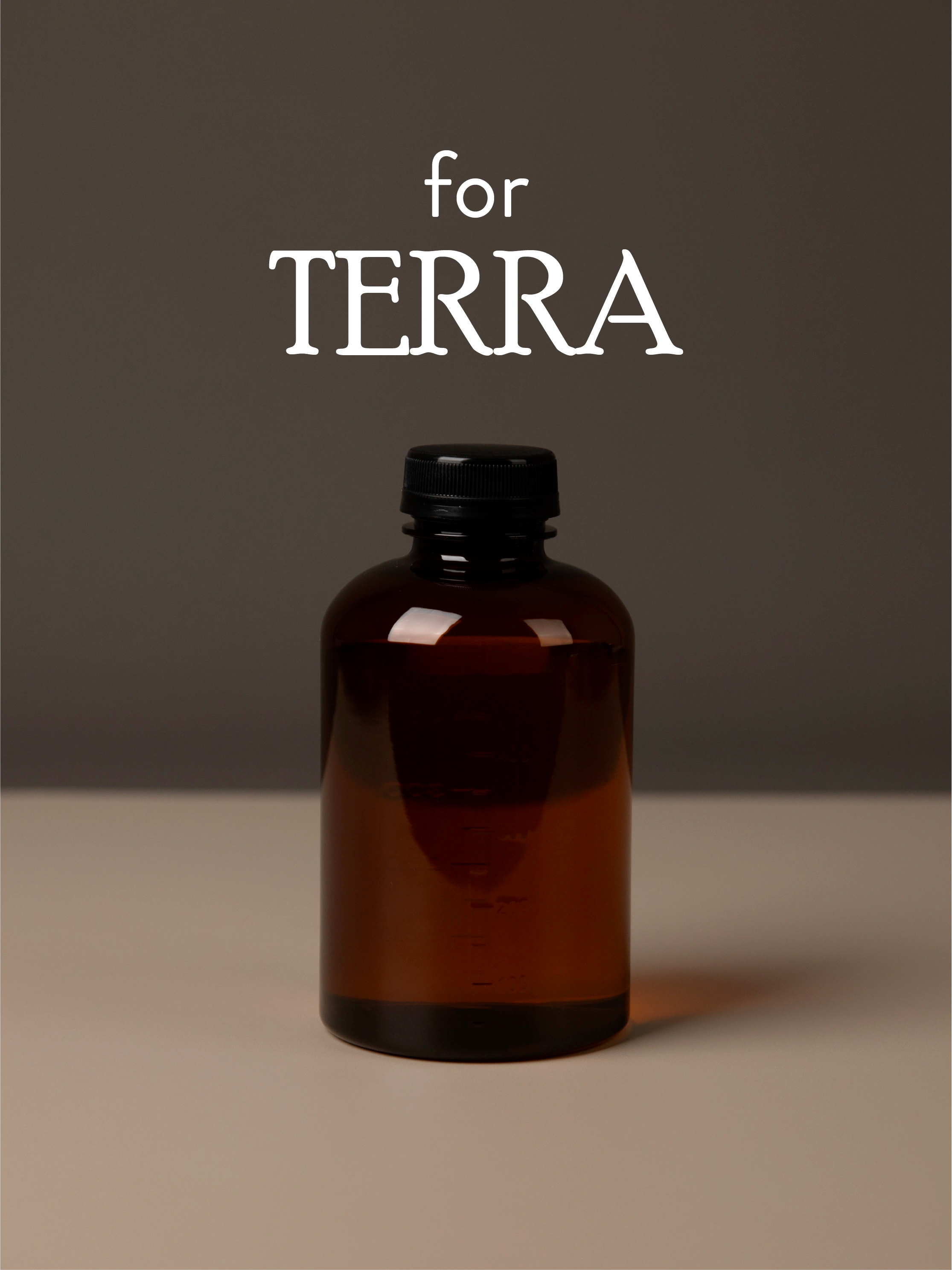 Amber diffuser oil bottle with black cap on a brown background with 'for TERRA' text.