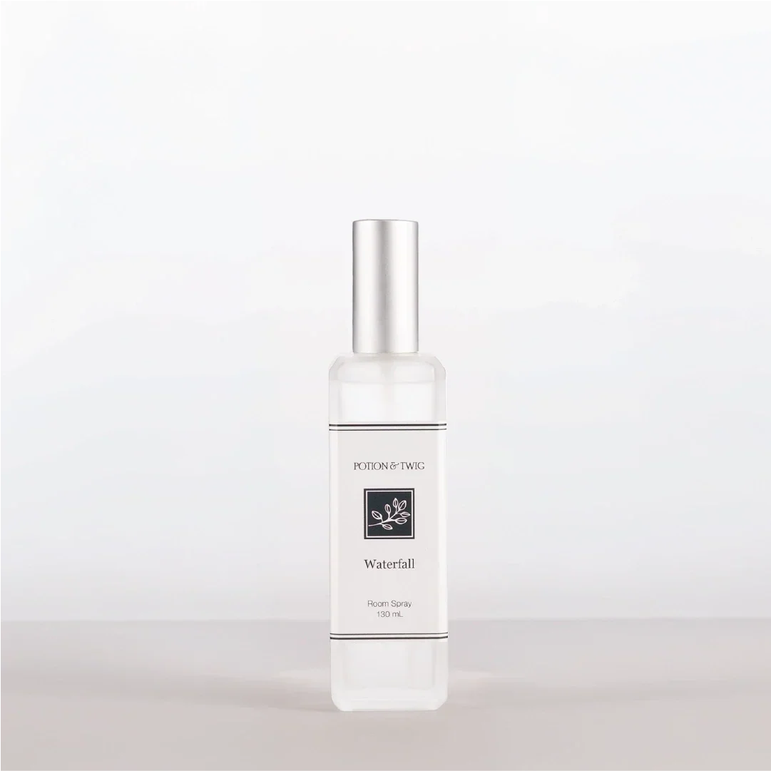 Luxury Room Spray in a clear rectangular bottle with a silver cap, white label, and Waterfall fragrance name