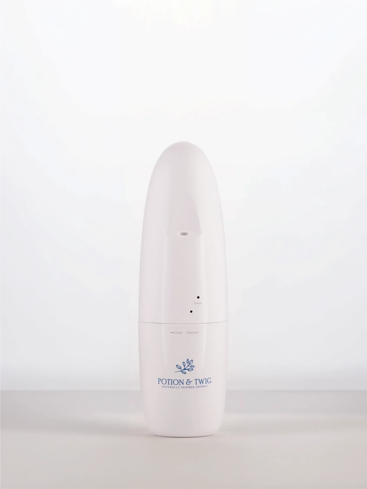 Sienna Diffuser in a slim white cylindrical case with a rounded top, small indicator holes, and blue Potion & Twig logo