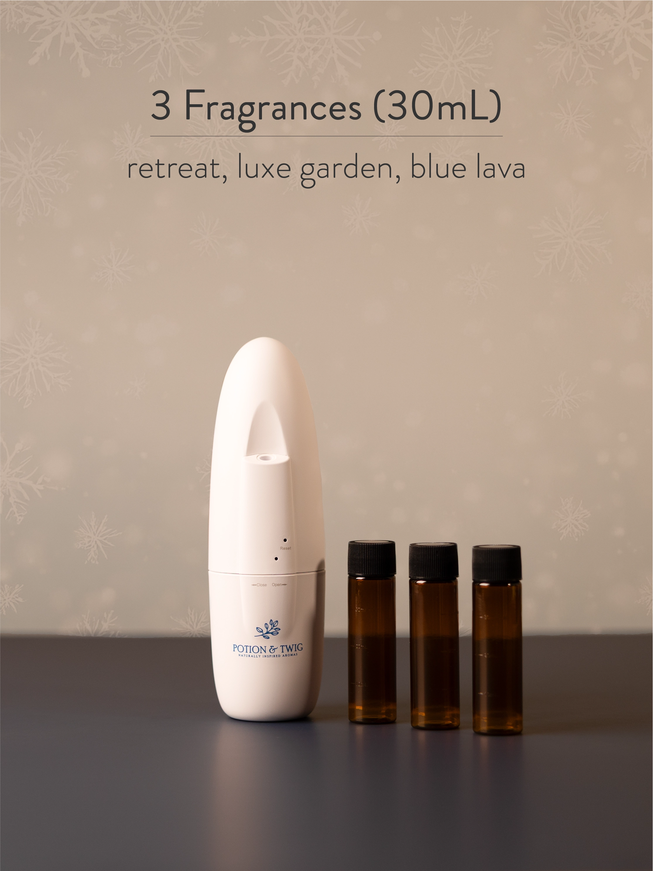 White Sienna scent diffuser next to 3 bottles of fragrance oil. 