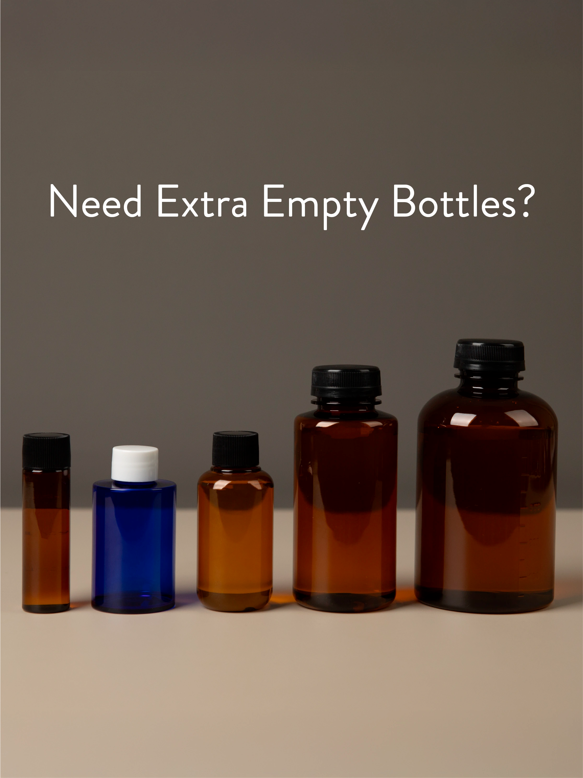 Set of empty diffuser oil bottles with different sizes on a neutral background