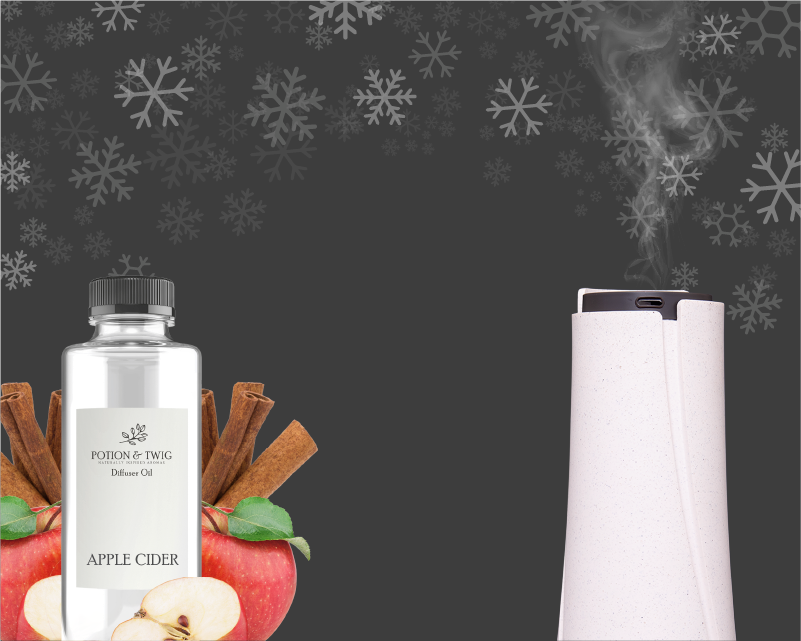 Diffuser and  diffuser oil bottle with apples and cinnamon sticks on a dark background with snowflake patterns.