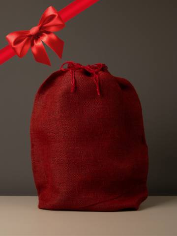 Red drawstring gift bag with a red ribbon on a gray background