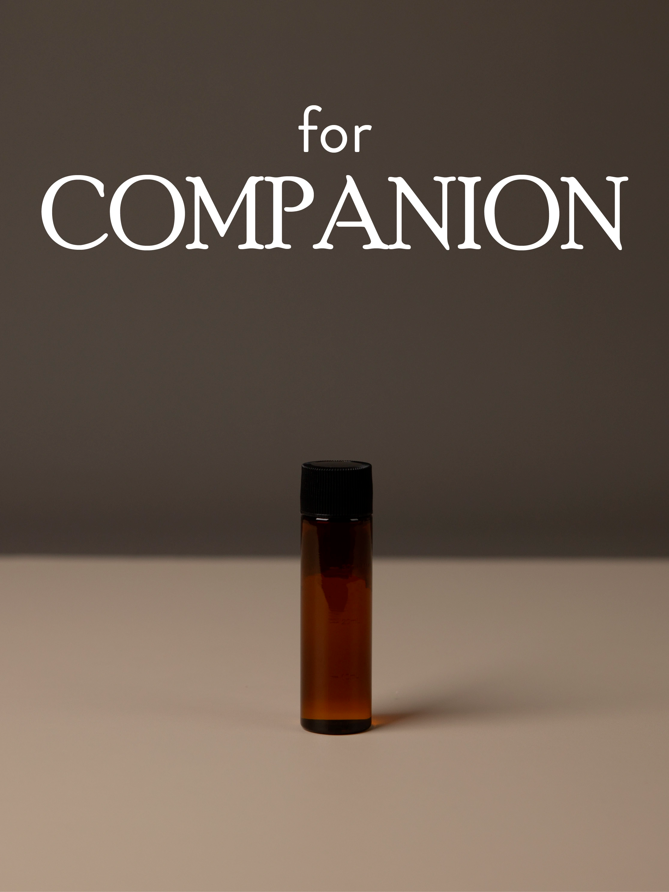 Brown diffuser oil bottle with black cap on a gray background, featuring the text 'for COMPANION'.