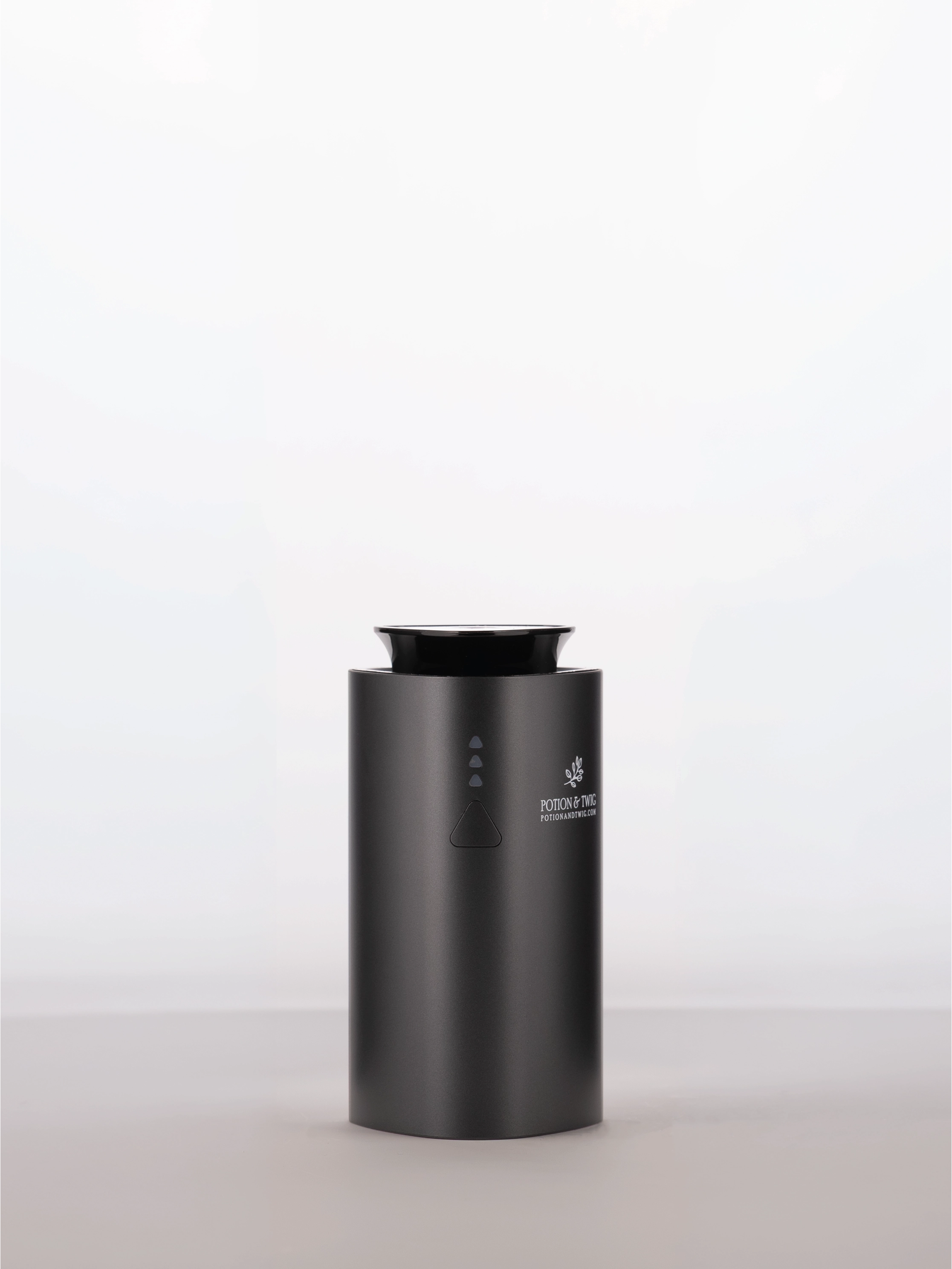 Black cylindrical scent diffuser with 'Potion & Twig' brand logo on a white background