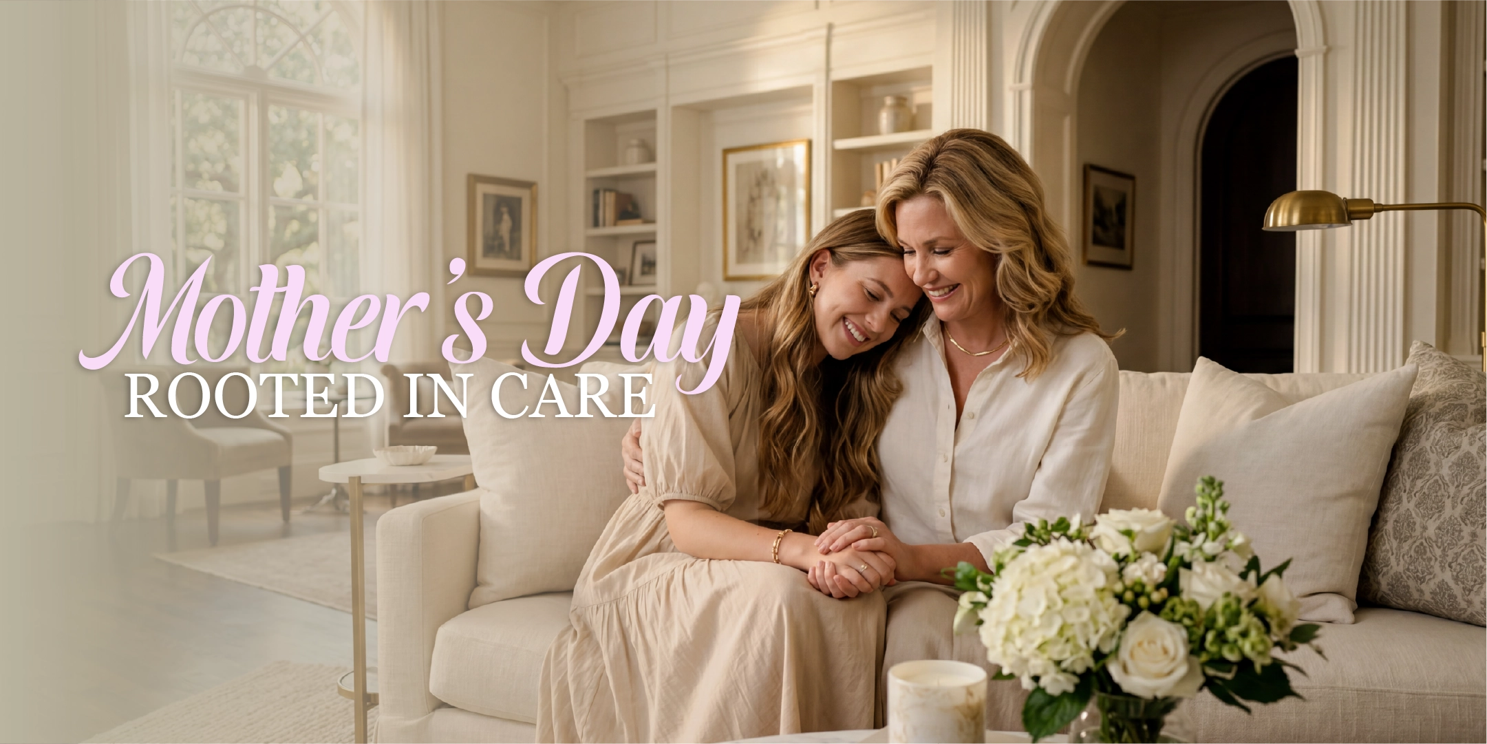 Two women sitting on a couch in a living room with 'Mother's Day Rooted in Care' text.