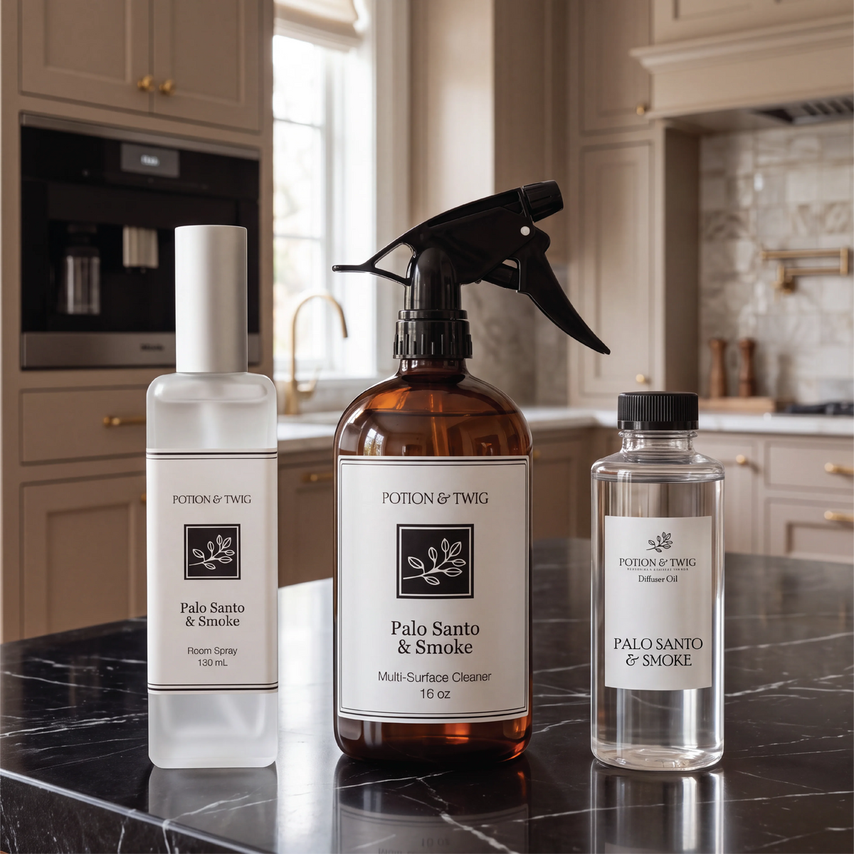 Three bottles all labeled Potion & Twig. A Room Spray square bottle with the fragrance Palo Santo & Smoke. A 16oz Surface cleaner bottle and a 100mL bottle of Palo Santo & Smoke Diffuser oil. In a modern high end kitchen setting. On a black marble countertop. 