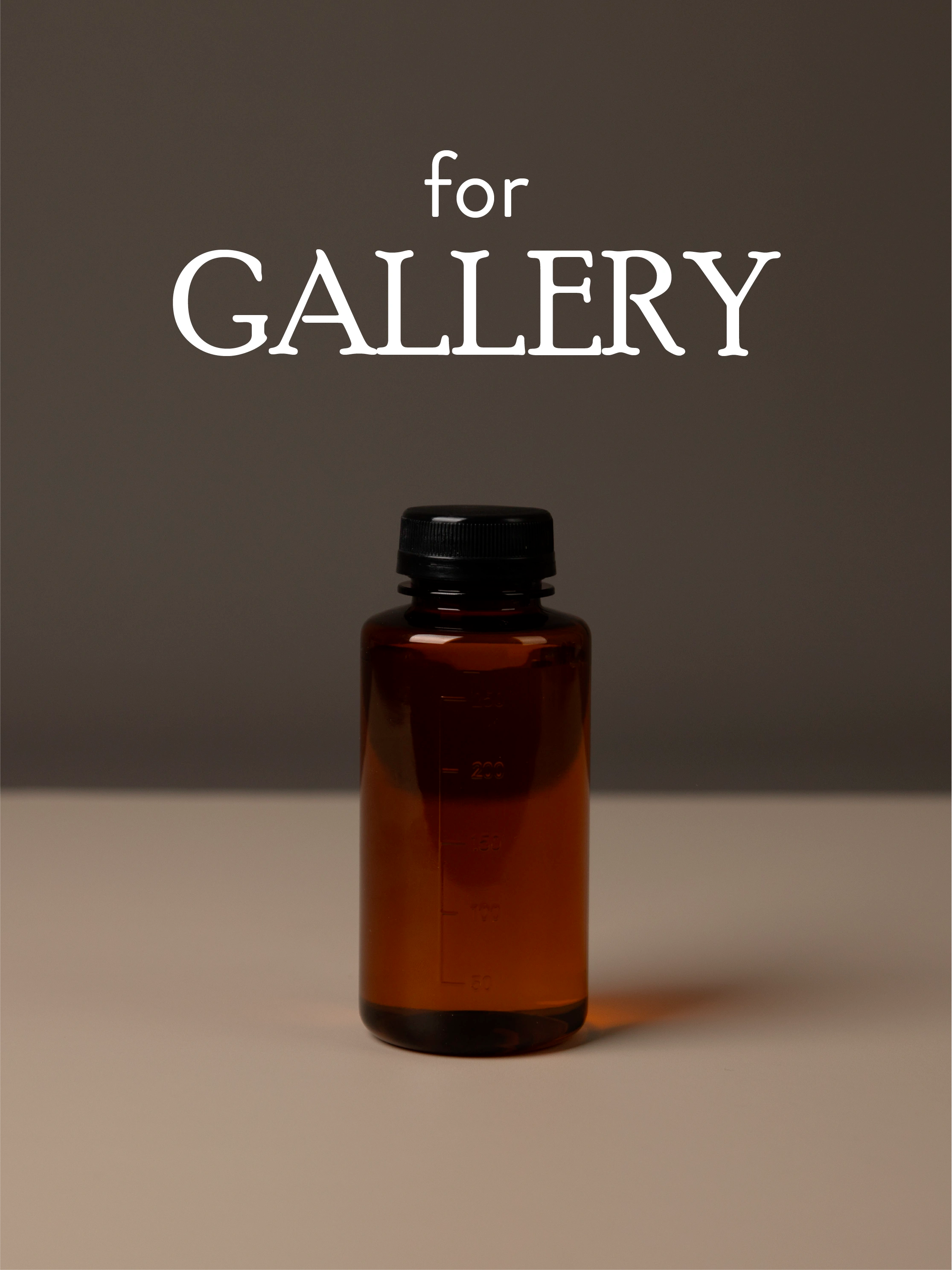 Amber diffuser oil bottle with black cap on a brown background with 'for GALLERY' text.