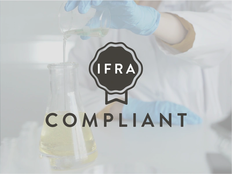 Laboratory setting with a person in gloves holding a beaker, overlaid with 'IFRA Compliant' text and logo.