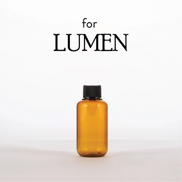 Amber bottle with black cap on a white background, featuring the brand 'LUMEN'.