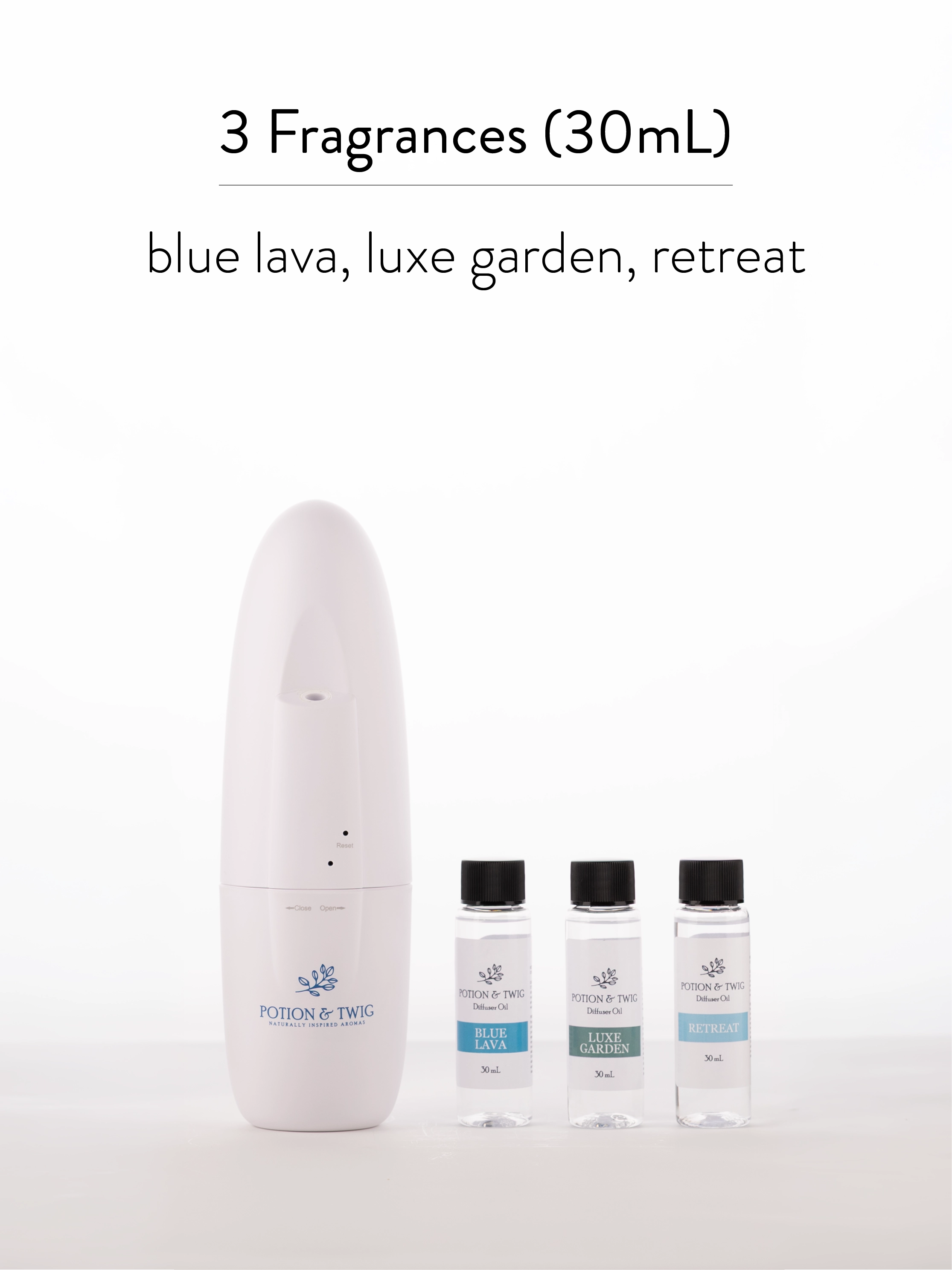 White diffuser with three smaller bottles labeled 'blue lava', 'luxe garden', and 'retreat' on a white background.