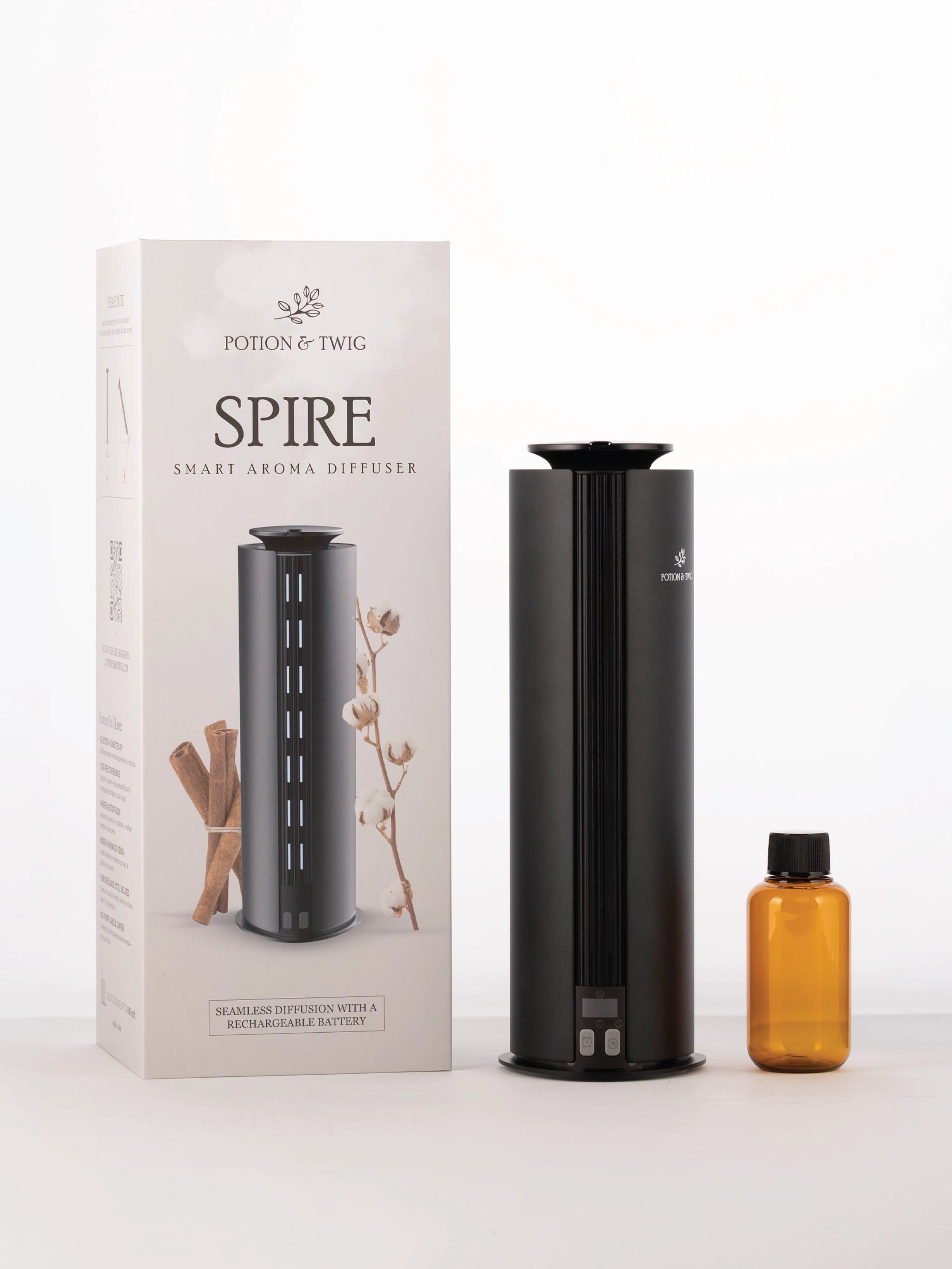 Spire smart aroma diffuser with packaging and a bottle on a white background