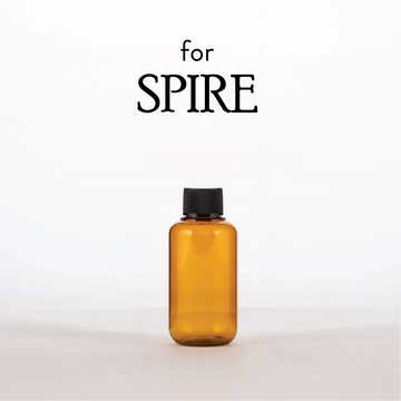 Amber bottle with black cap on a white background, featuring the brand 'SPIRE'.
