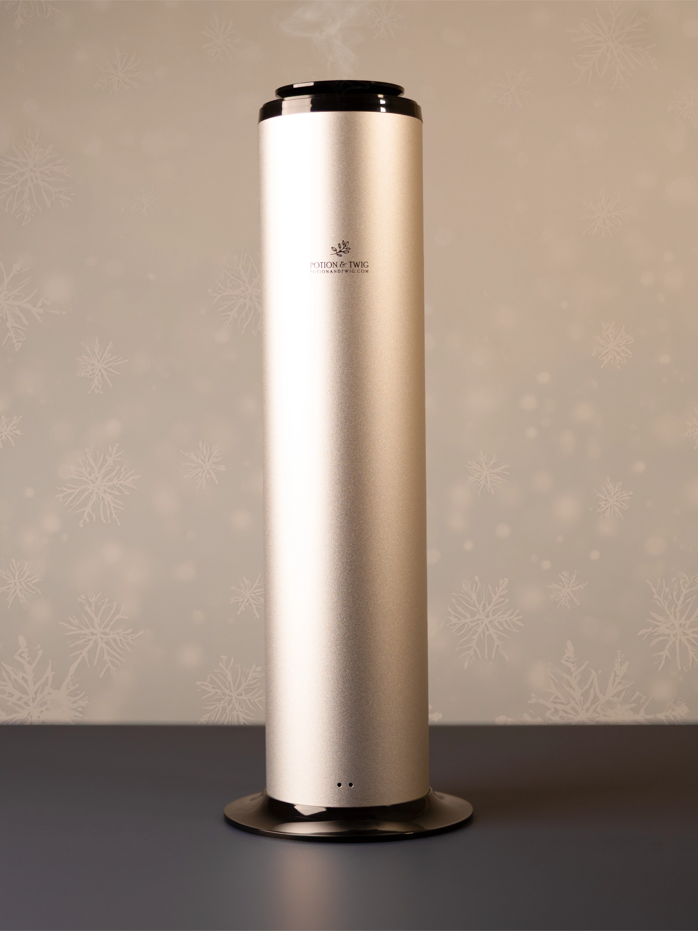 Tall cylindrical scent diffuser on light neutral background