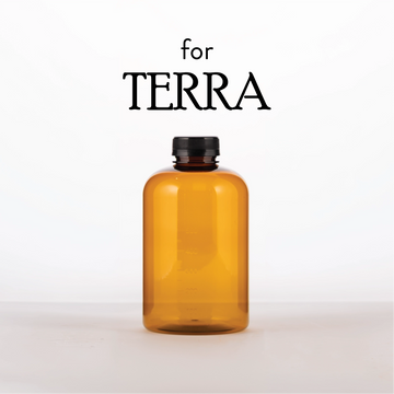 Amber glass bottle with black cap on a white background, branded 'TERRA'.