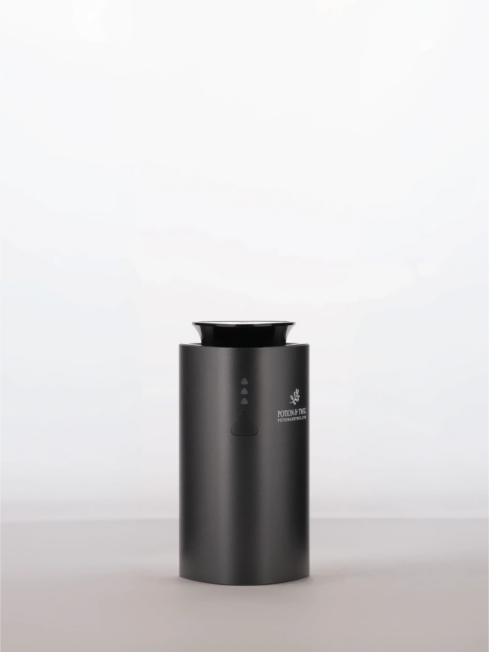 Companion Diffuser in matte black with a cylindrical body, top opening, and small front control buttons