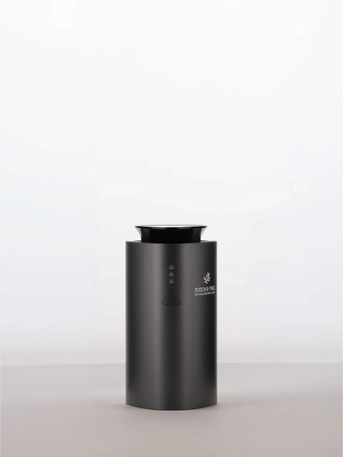 Companion Diffuser in matte black with a cylindrical body, top opening, and small front control buttons