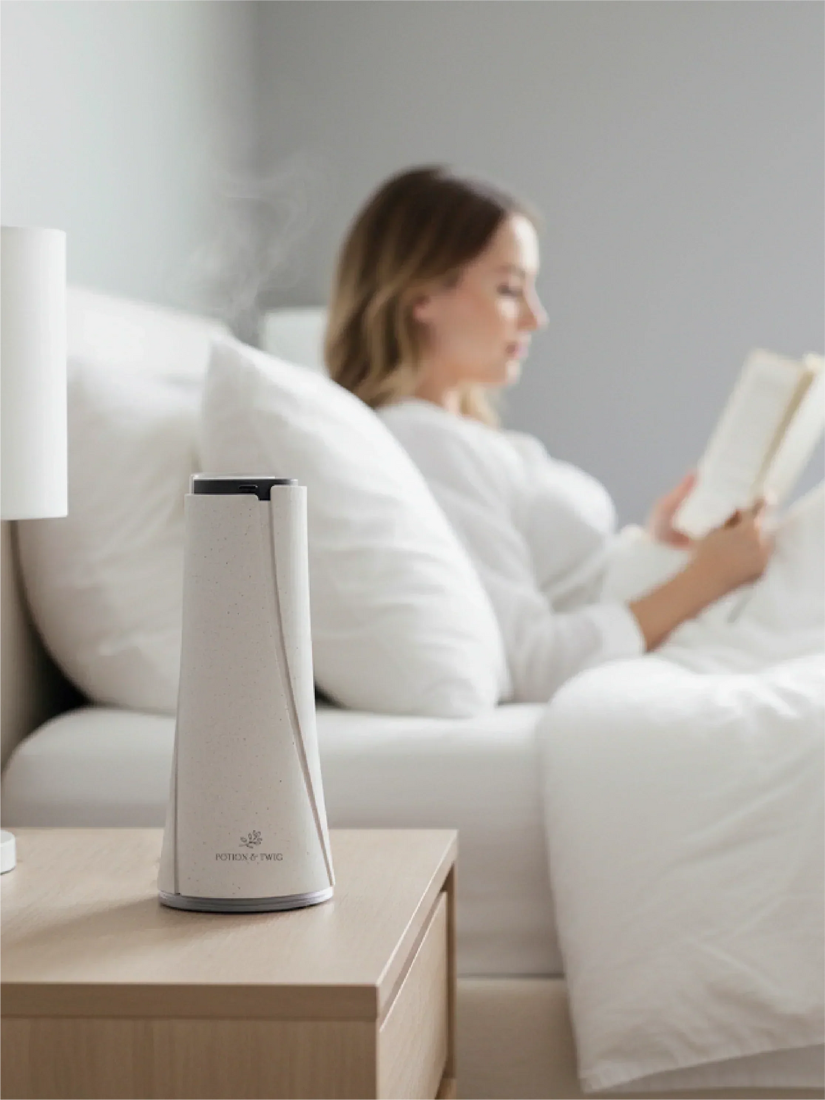 Lumen Smart Aroma Diffuser in a tapered ivory design with a dark top and subtle speckled finish