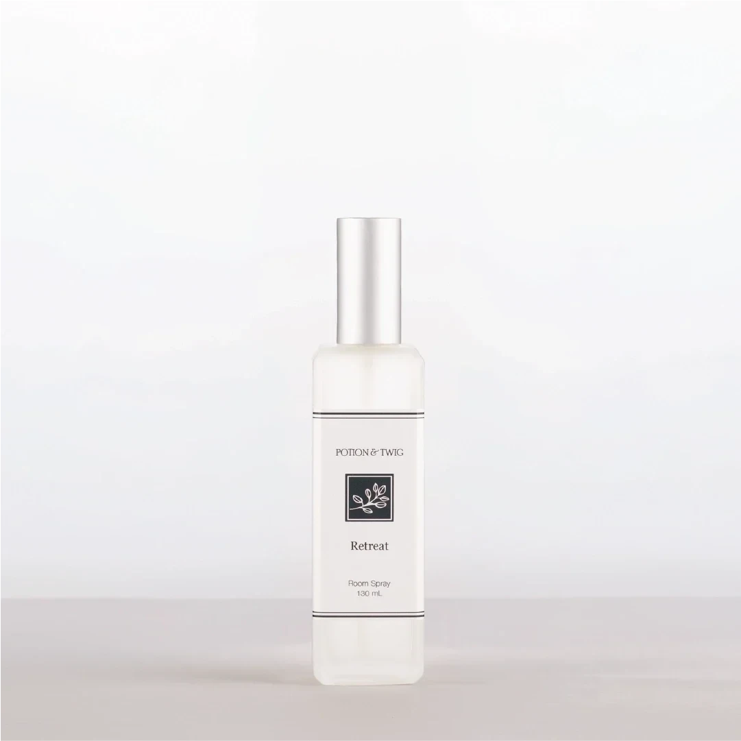 Luxury Room Spray in a clear bottle with a white label, silver cap, and minimalist botanical design