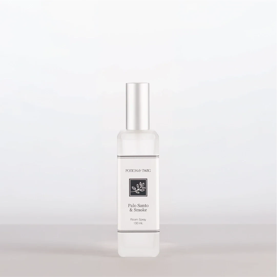 Luxury Room Spray in a clear glass bottle with a silver cap, white label, and Palo Santo & Smoke fragrance.
