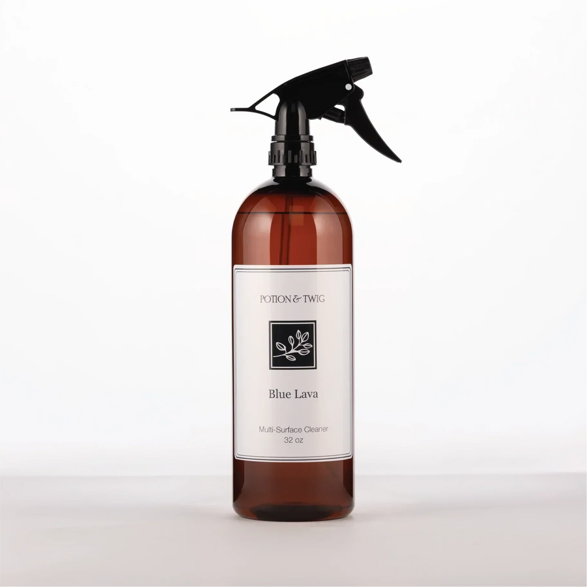 Luxury Surface Cleaner in an amber glass spray bottle with a black trigger and white Blue Lava label