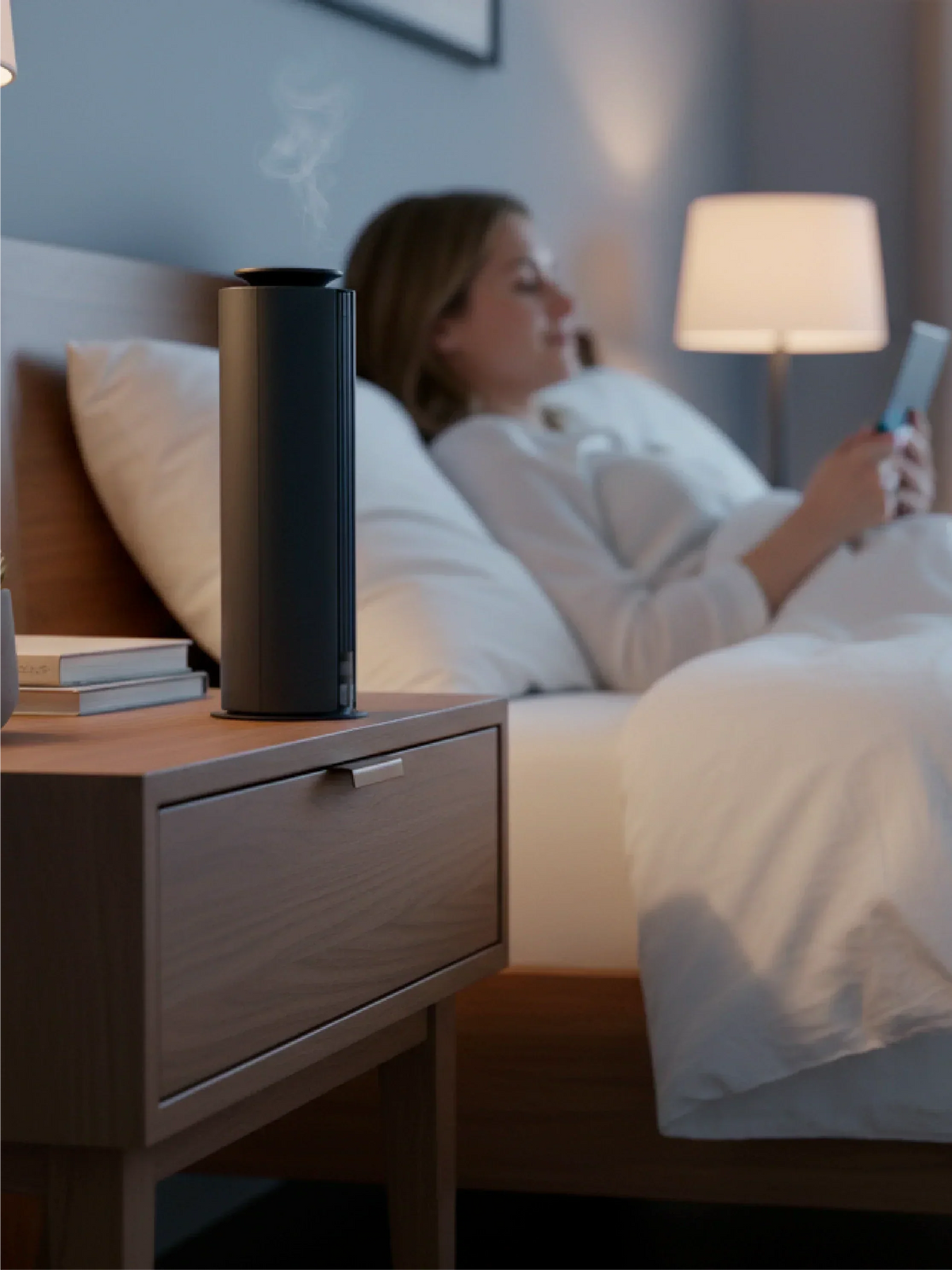 Spire Diffuser, a slim black cylindrical aroma diffuser with a subtle mist outlet and minimalist design
