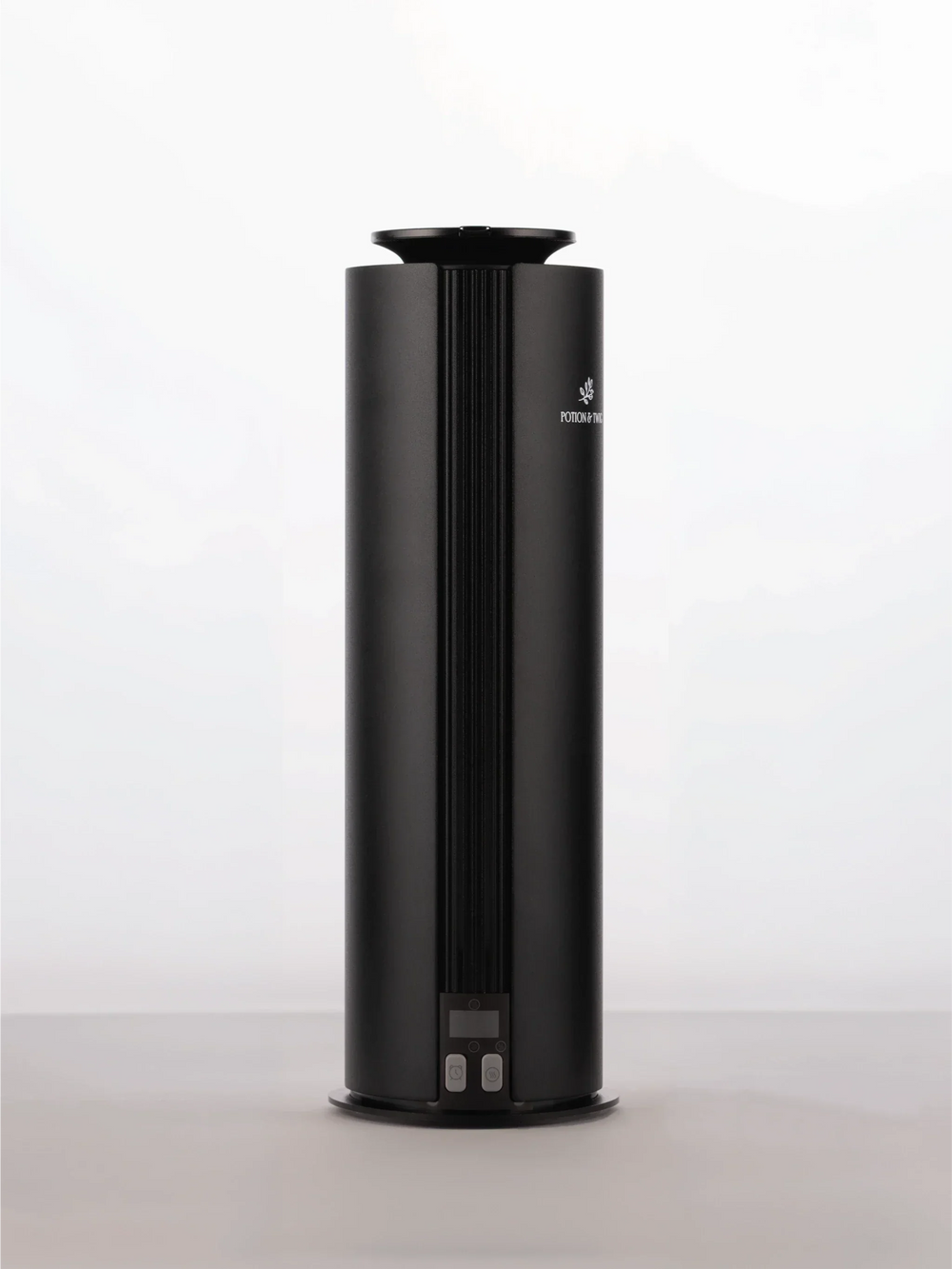 Spire Diffuser, a sleek black cylindrical aroma diffuser with a ribbed front panel and small base controls