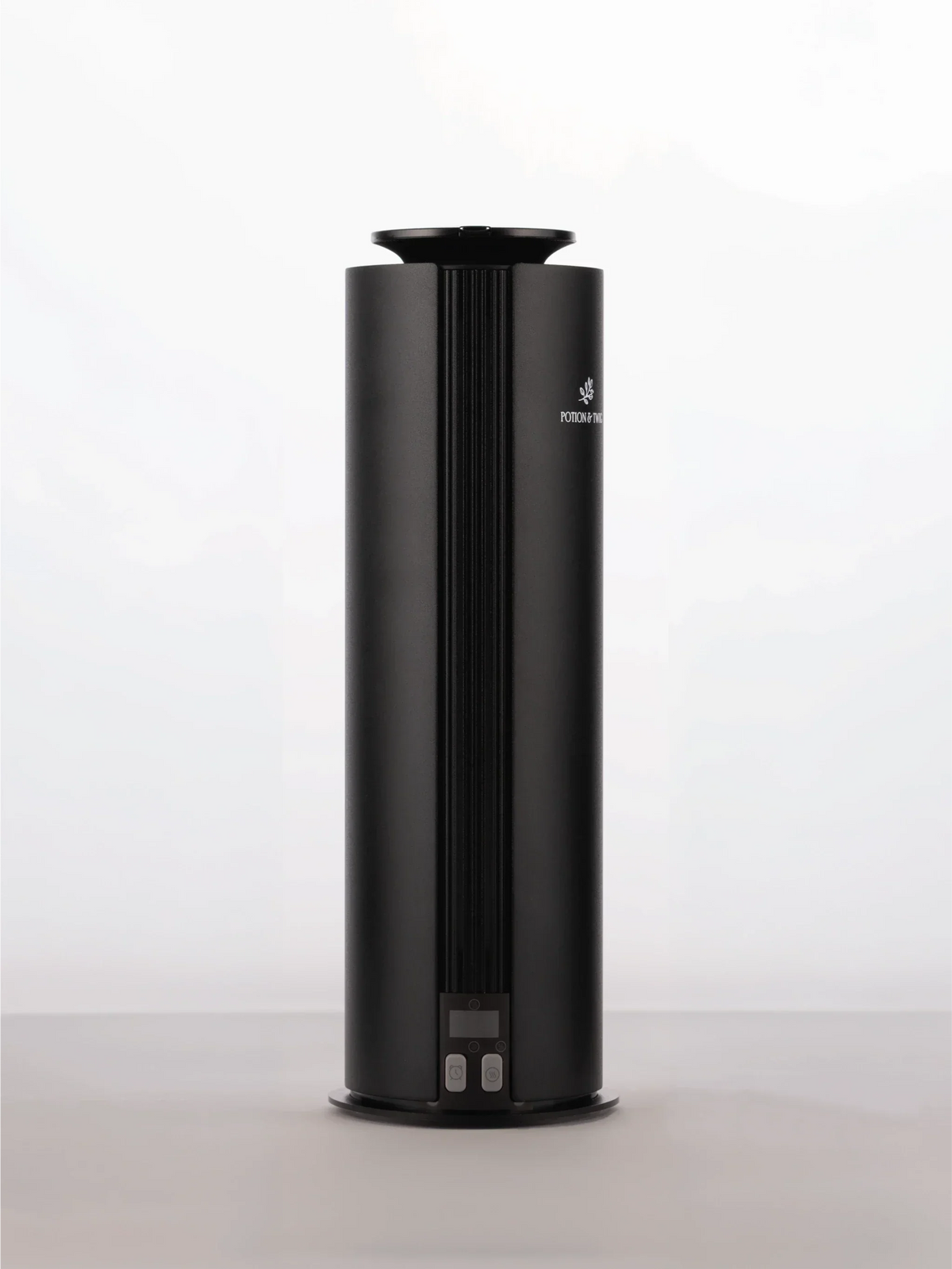 Spire Diffuser, a sleek black cylindrical aroma diffuser with a ribbed front panel and small base controls